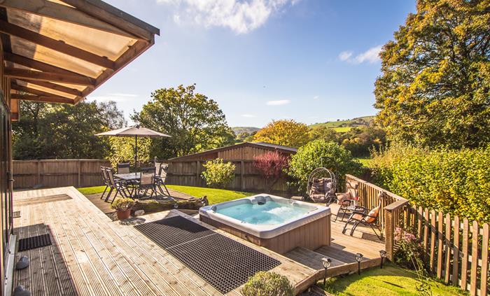Ash Lodge veranda and patio with views across the countryside within a secure garden.